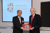 Dr Wu Po-him, Philip, BBS, JP, Chairman of the Board of Trustees presents a publication of the Lord Wilson Heritage Trust as souvenir to Lord Wilson