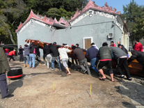 Members of the Joint Association move the new dragon boat into the dragon boat dockyard next to Tai O's Yeung Hau Temple