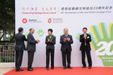 Five officiating guests pasting palms to backdrops reflecting the theme of “Conserving Heritage Hand in Hand”